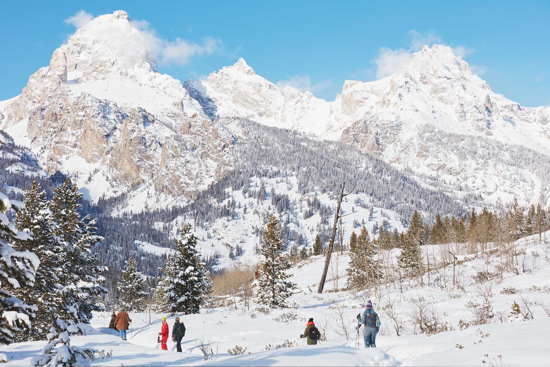 People snow shoeing in the mountains