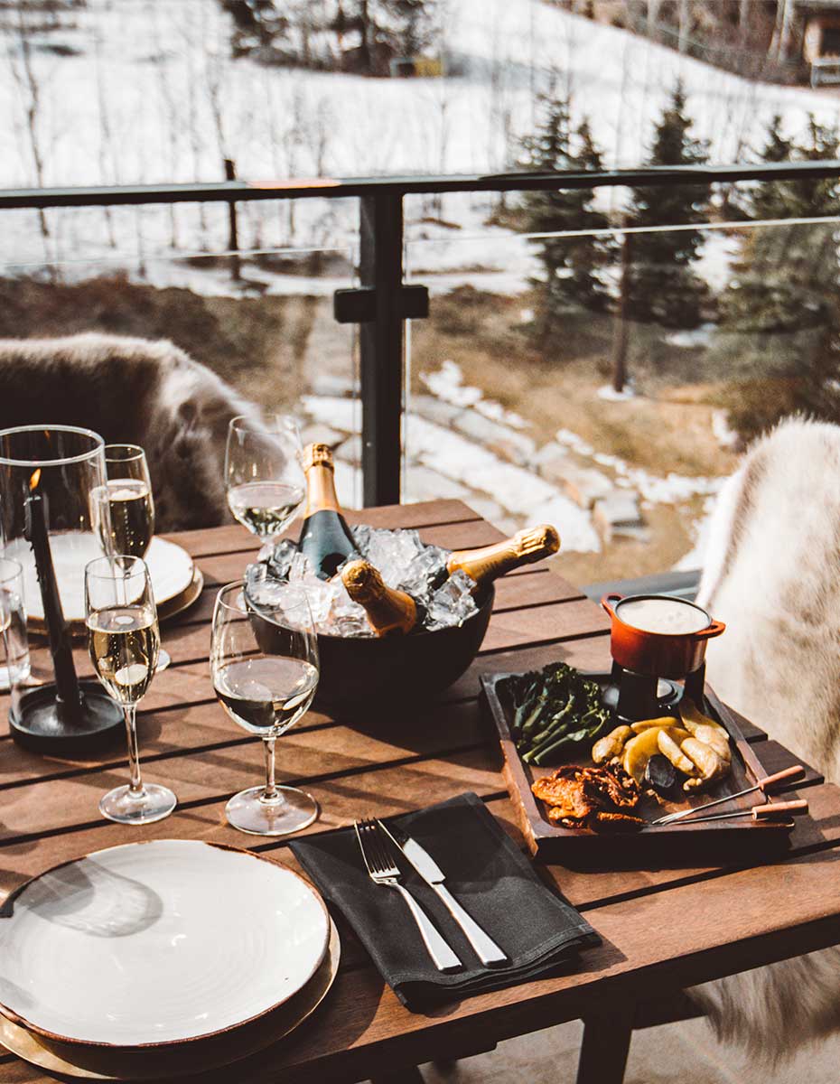 Patio with bottles of champagne and a fondue set