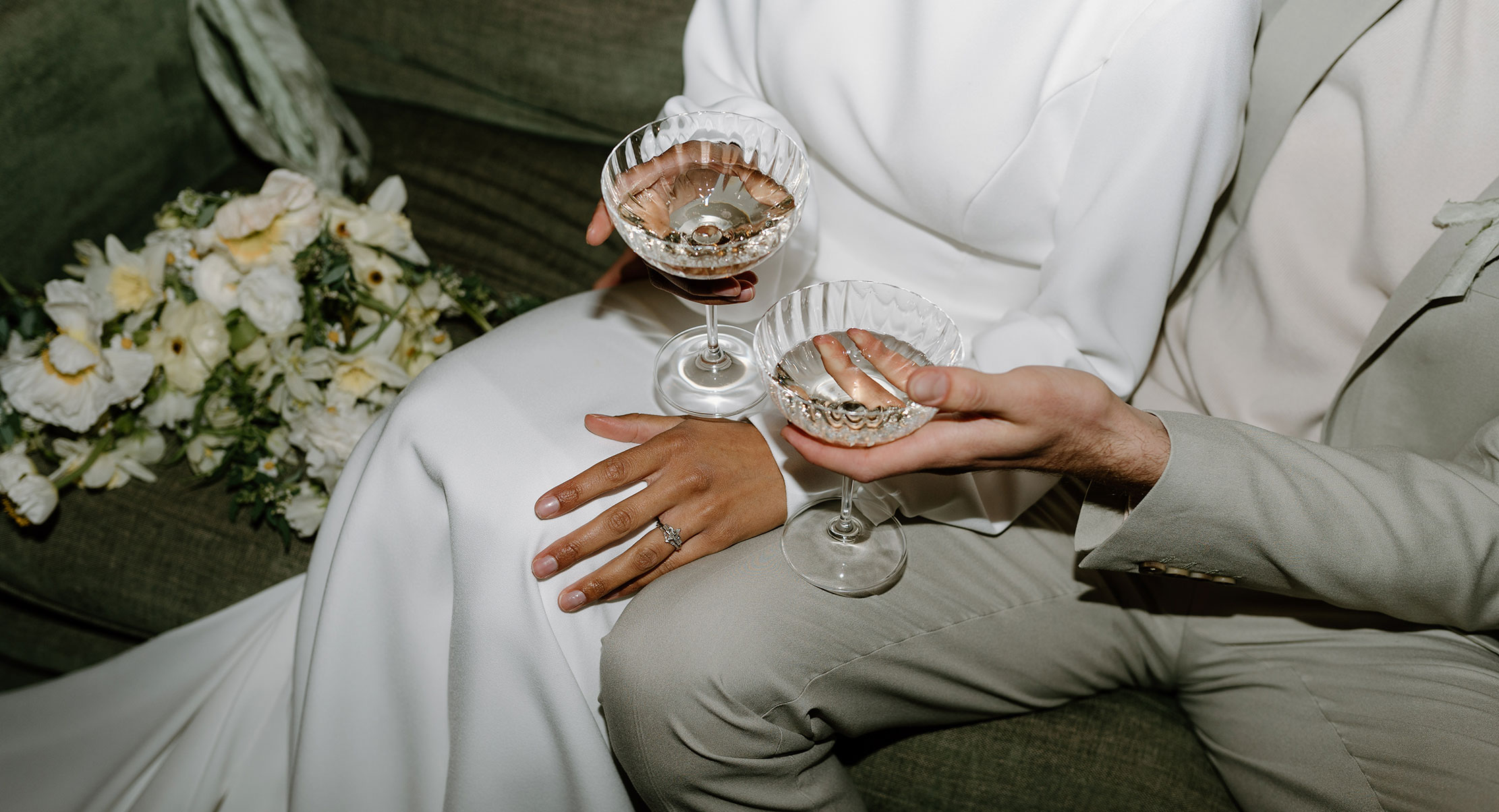 Intimate wedding couple holding champagne